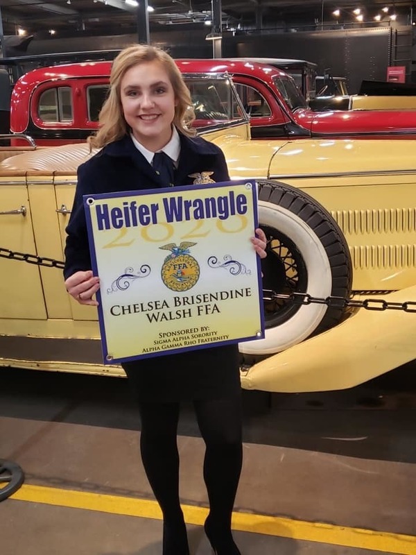 Chelsea Brisendine holding her sign for "Heifer Wrangler" at FFA convention